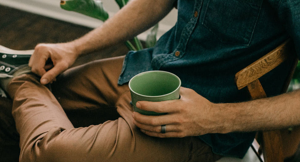 Man holding cup of tea