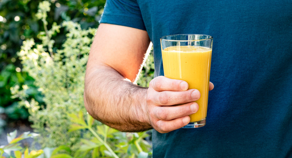 2. Athletic man holding turmeric protein shake